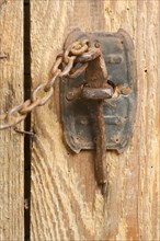 Antique rusty barn door latch and chain