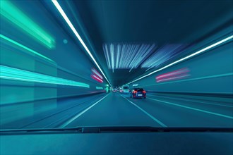 Highspeed in the tunnel. View through the driver's windscreen of a car as a long exposure with light pullers and racing feeling