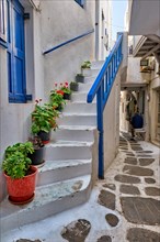Picturesque scenic narrow Greek streets with traditional whitewashed houses with blue doors windows of Mykonos town in famous tourist attraction Mykonos island