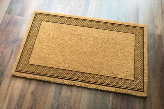 Blank welcome mat on wood floor background ready for your own text