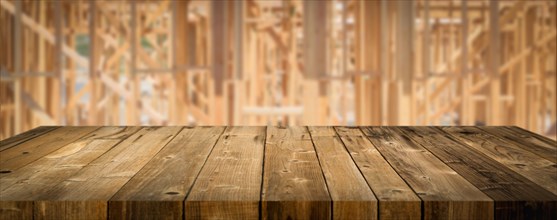 Empty wood table surface display background with construction theme behind