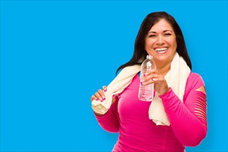 Middle aged hispanic woman in workout clothes with towel and water bottle against A cyan blue background
