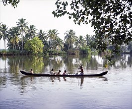 Children being taken in a boat across the back waters of Alappuzha or Alleppey in Kerala