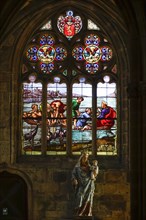 Choir gallery with leaded glass window and statue of the Virgin Mary