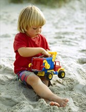 Little girl playing in the sandbox Photo: