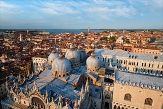 View of Venice with famous St Mark's Basilica and Doge's Palace on sunset from St Mark's Campanile bell tower
