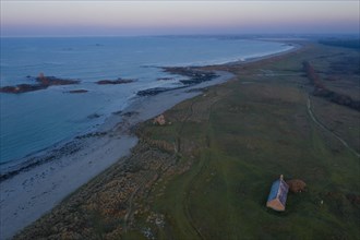 Aerial view of Ker Emma sandy beach and Keremma dunes with Chapelle Saint-Guevroc just in front of sunset