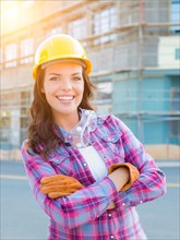 Portrait of young female construction worker wearing gloves