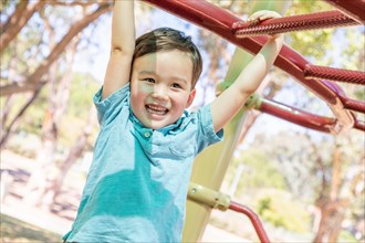 Chinese and caucasian boy having fun at the playground