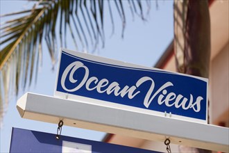 Ocean views real estate sign in front of house