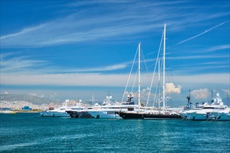 Luxury yachts and boats moored on summer day in port of Athens