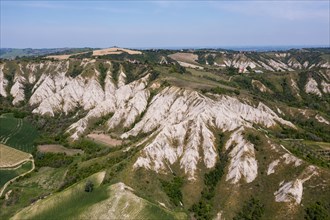 Aerial view of a hilly landscape with erosion valleys