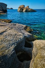 White rocks of famous tourist attraction of Milos island Sarakiniko beach and Aegean sea