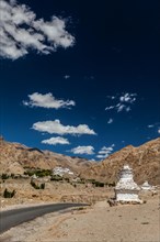 Whitewashed chortens Buddhist stupas near Likir monastery. Ladakh