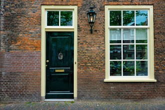 Holland street view Old house door and window. Delft