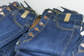 Close up of blue jeans over others