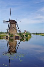 Historic windmills reflected in a canal