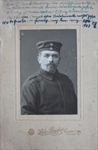 Man in uniform jacket and with cap