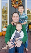 Young mixed-race chinese and caucasian father with his sons