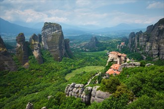 Sunset over monastery of Rousanou and Monastery of St. Nicholas Anapavsa in famous greek tourist destination Meteora in Greece