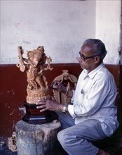 A craft man with his sandalwood Ganesha in Mysuru or Mysore