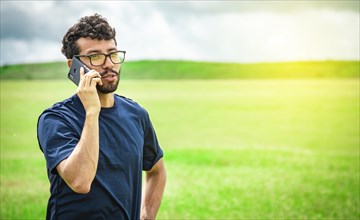 Man calling on the phone in the field