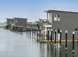 Pile dwellings as holiday homes with boat mooring