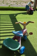 Plastic vehicle toys on green lawn