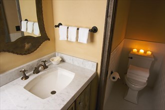 Rustic bathroom sink and toilet scene