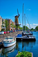 View of the harbour of Delfshaven with the old grain mill known as De Destilleerketel. Rotterdam