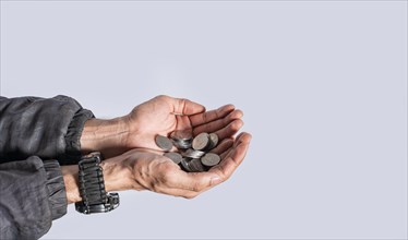 Hands with several coins in isolated background