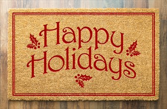 Happy holidays christmas tad welcome mat on wood floor background