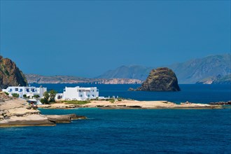 Greek fishing village with traditional whitewashed white houses on Milos island view from Aegean sea in Greece
