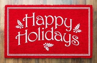 Happy holidays christmas red welcome mat on wood floor background