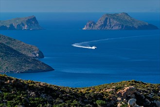 Speeding speed boat catamaran ferry vessel in Aegean sea near Milos island on summer day in Greece