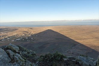 Mountain shadow in the shape of a triangle in the landscape