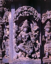 Close up of stone sculpture of dancing Lakshmi in Hoysala architecture at Somnathpur
