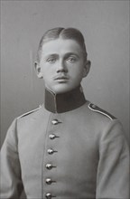 Man in uniform with correct centre parting and high collar