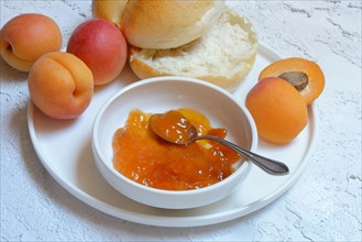 Apricot jam in shell and sliced roll