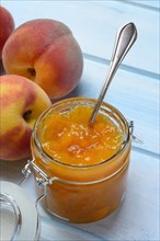Peach jam in glass and peaches