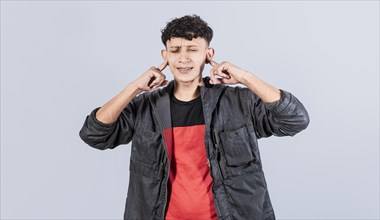 Man covering his ears isolated