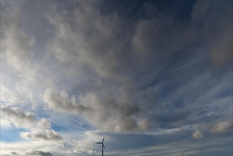 Cloudy sky with wind turbine