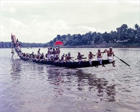 The colourful umbrellas taken in the boats by men in their traditional dress during Aranmula boat race
