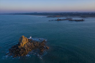 Aerial view of rock formations in the sea in front of the sandy beach Ker Emma shortly in front of sunset