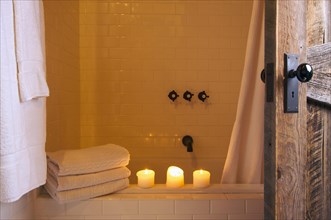 Rustic bathroom scene with towels and candles