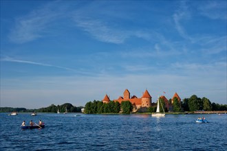 Trakai Island Castle in lake Galve with boats and yachts in summer day with beautiful sky