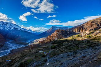 Dhankar monastry perched on a cliff in Himalayas and Spiti valley on sunset