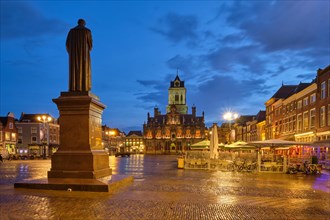 Delft City Hall and Delft Market Square Markt with Hugo de Groot Monument in the evening. Delft