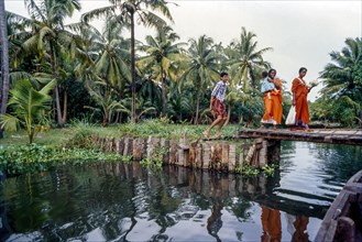 People walking through the footbridge over the backwaters of Alappuzha