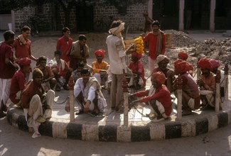 A group of Railway porters leisurely sitting on road roundana at Jaipur